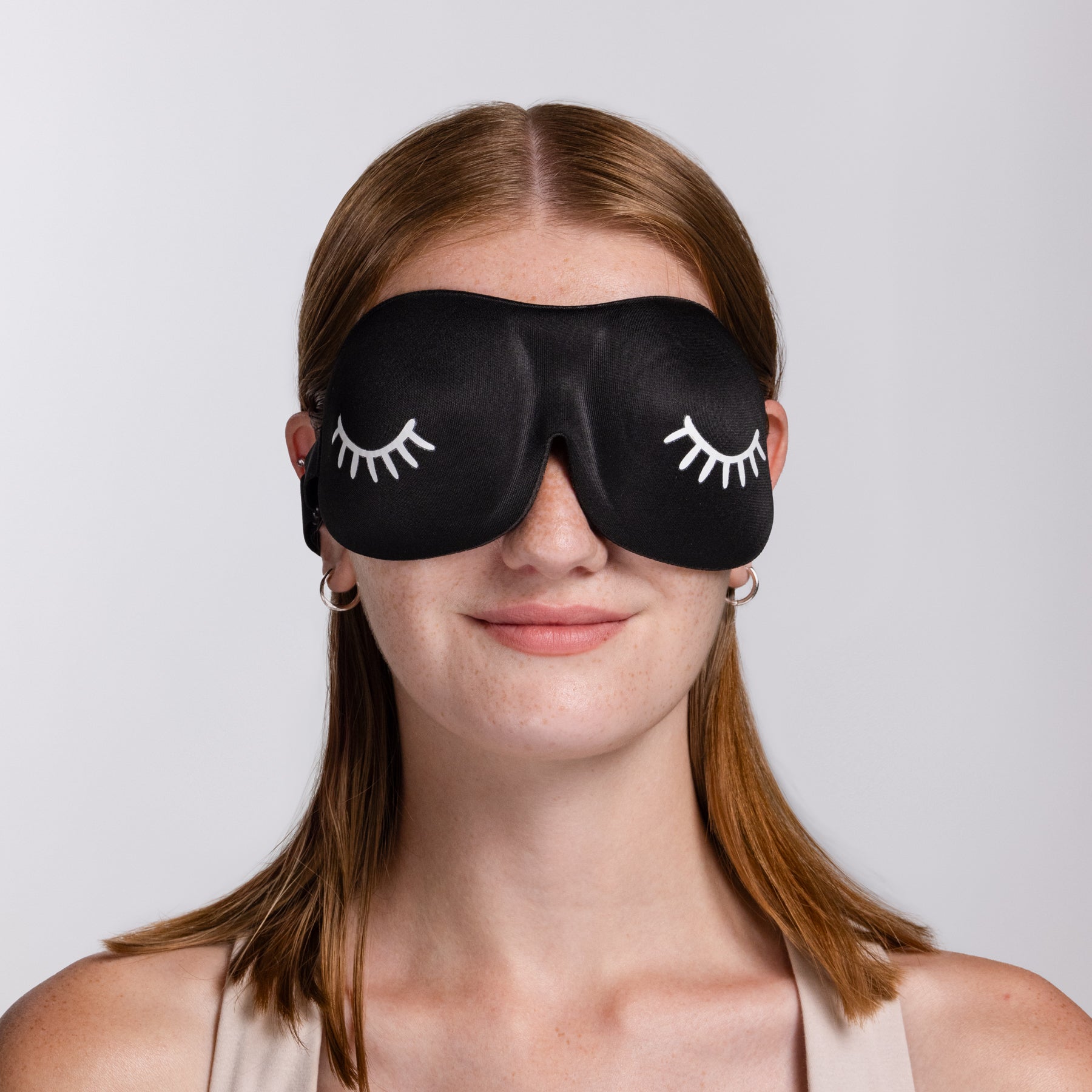 A model wearing 3D Foam Sleep Masks for Eyelash Care.