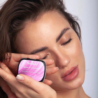 Brow styling soap held in hands of a model