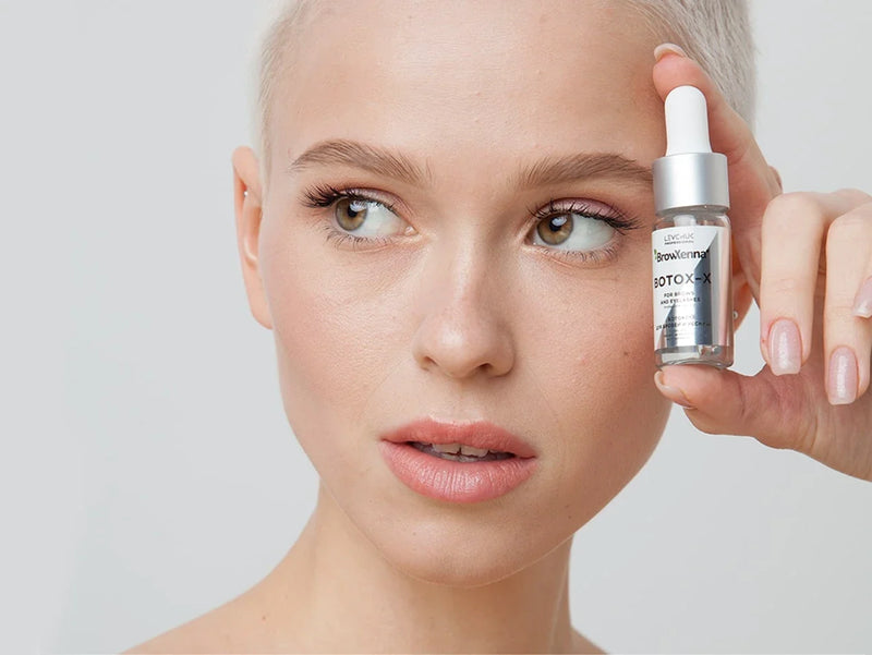 Model holding BrowXenna® Botox-X 10 ml bottle