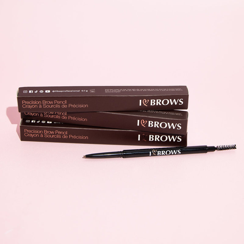 Three I ❤️ Brows Brow Pencil inside the boxes and one outside in front of a pink background.