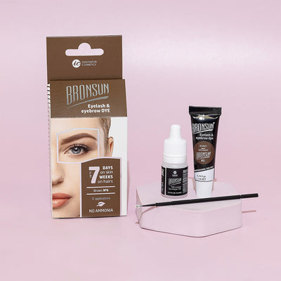 Eyelash and eyebrow brown dye tube, milk cream developer, and microbrush displayed with packaging aside