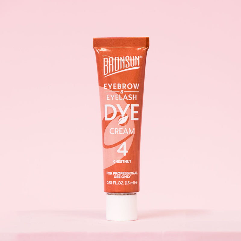 Chestnut eyelash and eyebrow dye cream tube displayed against a pink background