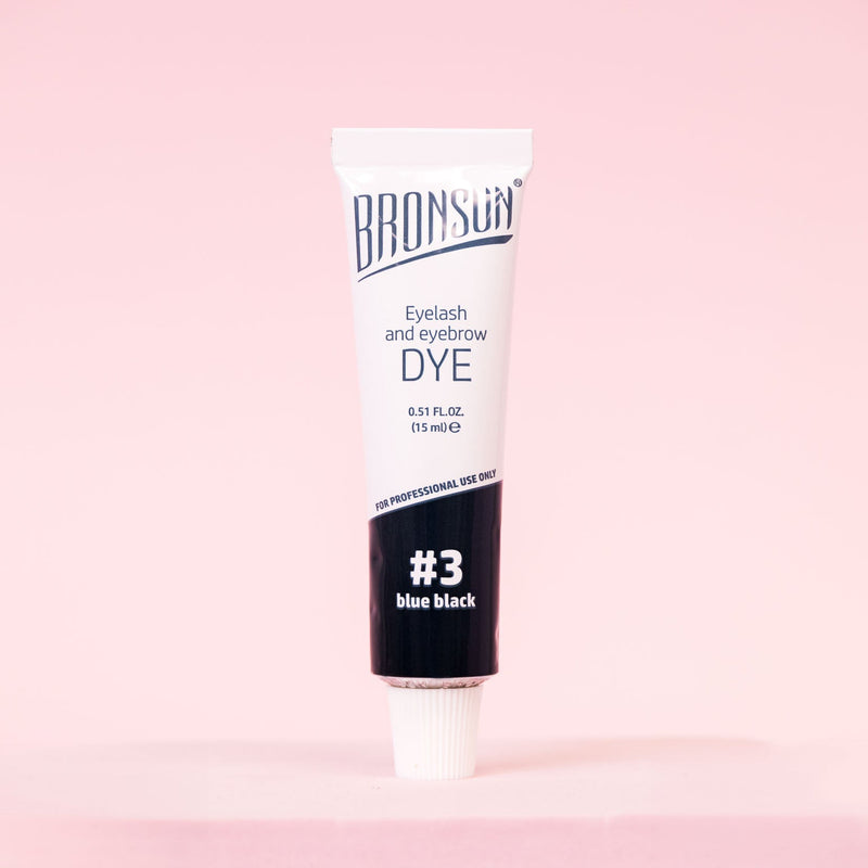 Bronsun Brow and Lash Dye - Blue Black tube on pink background displayed 