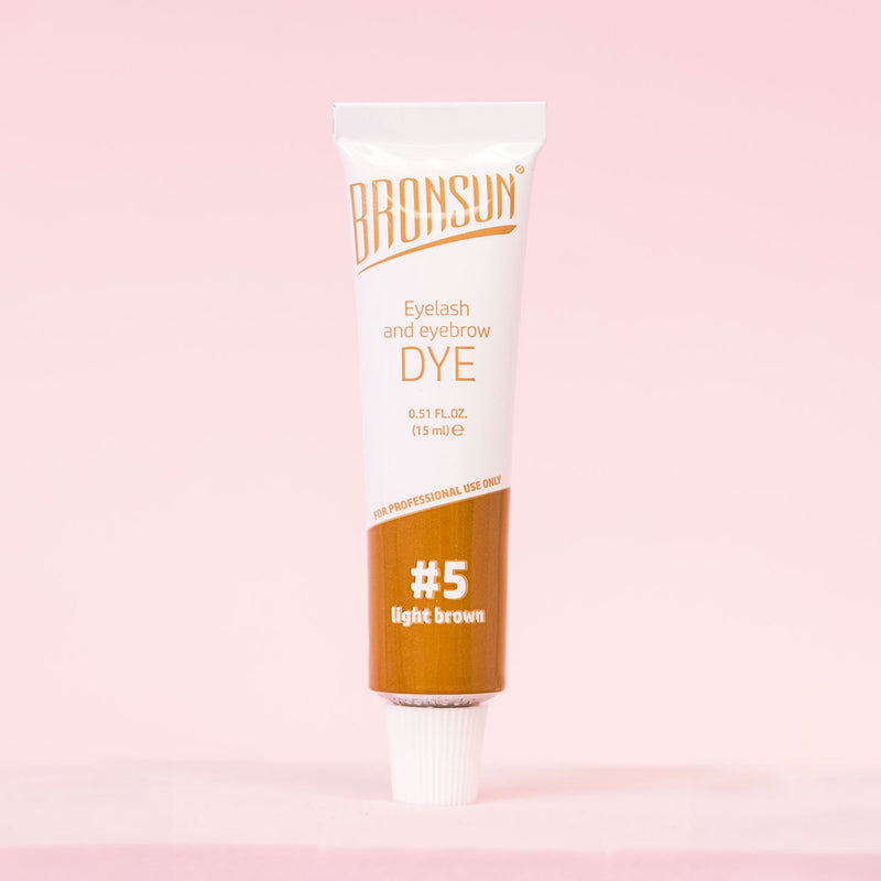 Bronsun Brow and Lash Dye - Light Brown product displayed on a pink background. 