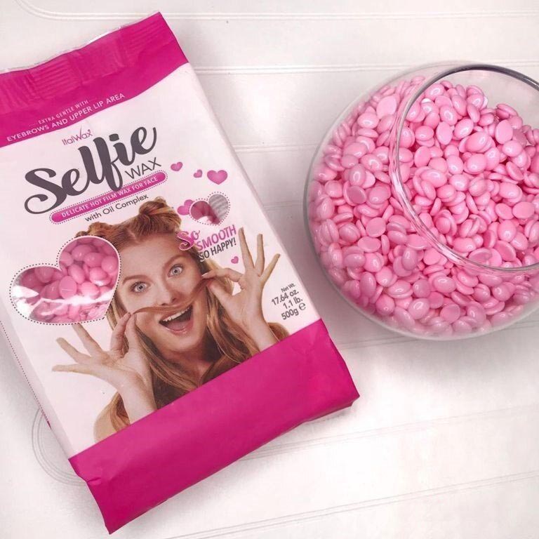 ItalWax Selfie Wax pack next to a bowl of pink wax beads on a white background.