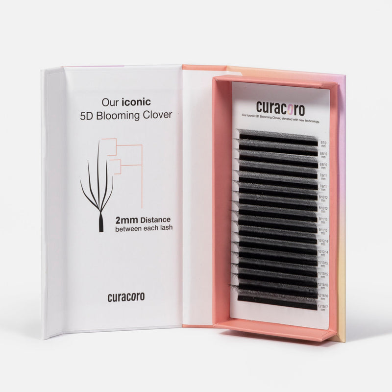 An open box of Curacoro 5D Blooming Clover eyelash extensions, highlighting a 2mm distance between each lash for optimal volume.