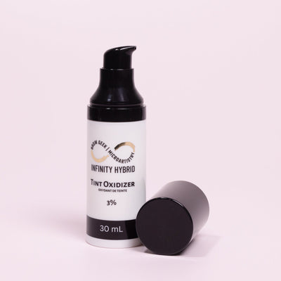 Infinity Hybrid Cream Tint Oxidizer 30ml Bottle Over Pink Background