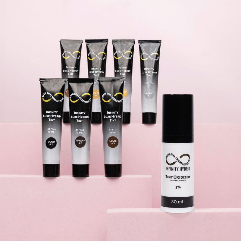 Infinity Luxe Hybrid Tint collection with Tint Oxidizer 3%, displayed on a pink background.