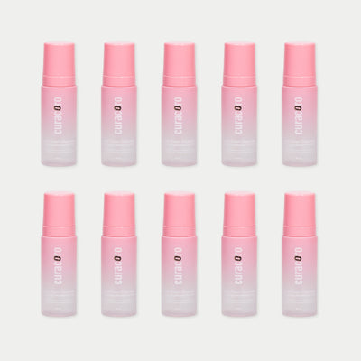 Ten Curacoro Lash Foam Bath 60ml (Rose Scented) in a grid pattern on a light background, featuring pink pumps.