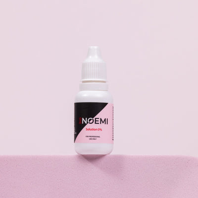 Noemi Developer Corrector 0% Bottle Over Pink Background