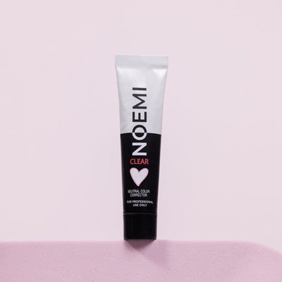 Noemi Neutral Color Corrector Bottle Over Pink Background