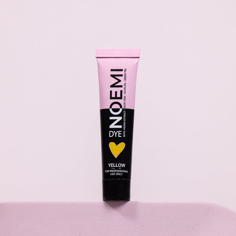 Noemi Hybrid Brow & Lash Dye - Yellow (Corrector) Bottle Over Pink Background