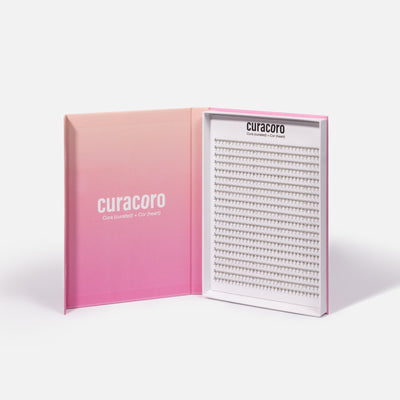 Curacoro XL Promade Fans in Black. The elegant packaging features a gradient pink design with an open tray showcasing high-quality eyelash fans.