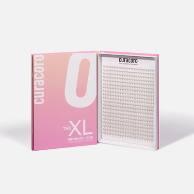 An open pink and white box labeled "The XL Promade Fans," displaying neatly arranged lash fans on a white background.