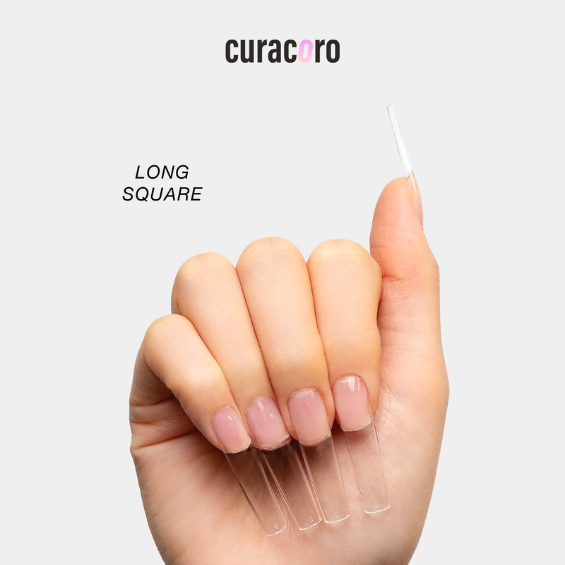 Curacoro soft gel nail tips in long square shape, applied on hand, displayed against a white background