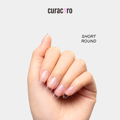 Curacoro soft gel nail tips in short round shape, applied on hand, displayed against a white background