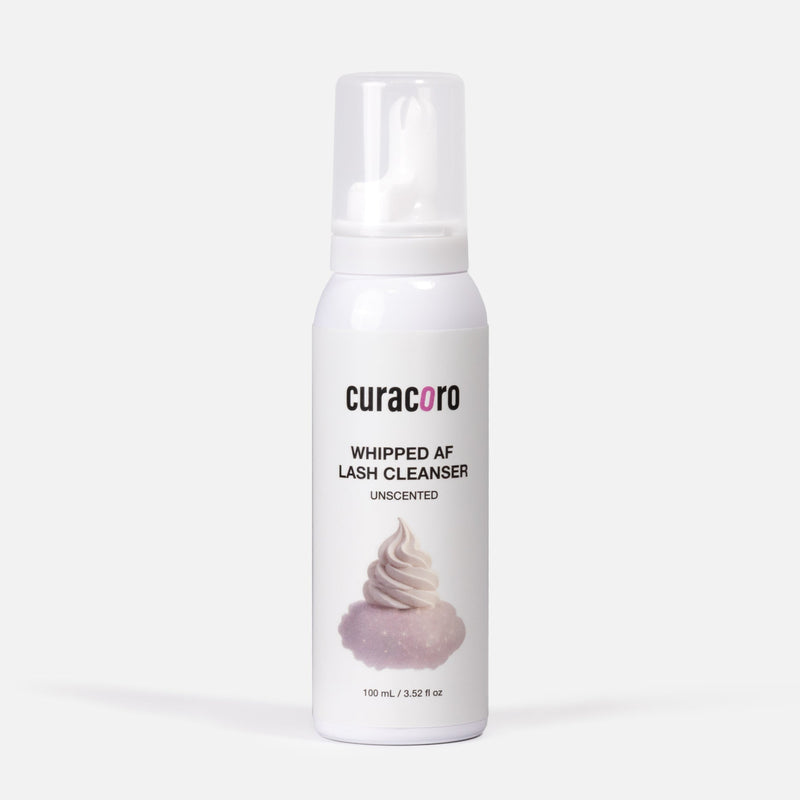White bottle of curacoro whipped AF lash cleanser on a white background
