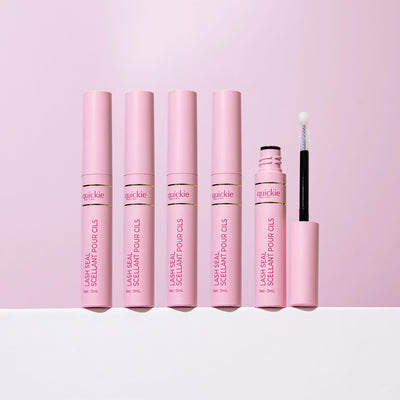 A lineup of five DIY Lash Extension Lash Seal, with one open to reveal the wand applicator, displayed against a light pink background.