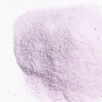 Close-up of powder texture spread across a white surface.