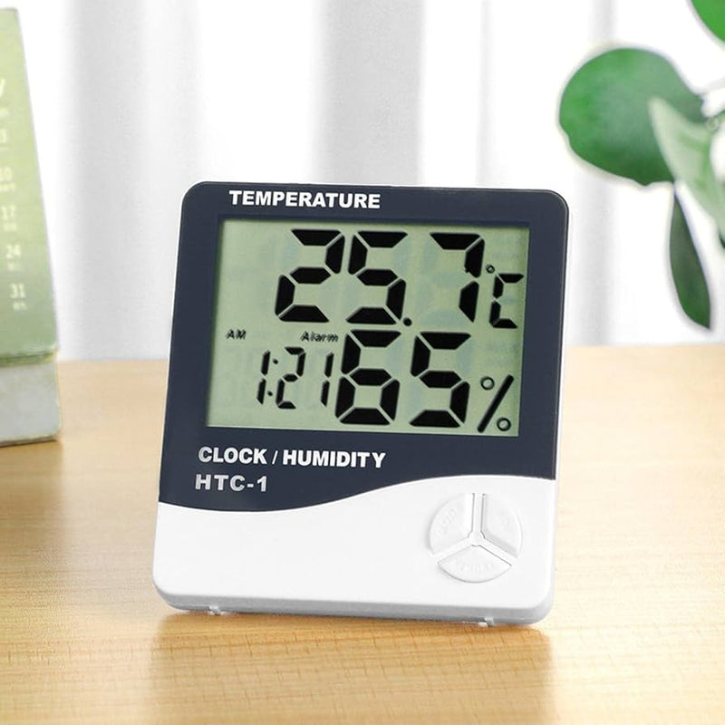 Digital hygrometer and thermometer displayed on a wooden surface, measuring temperature and humidity indoors.