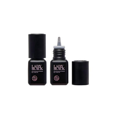 Two Lady black glue bottles for lash extensions, one with the lid open