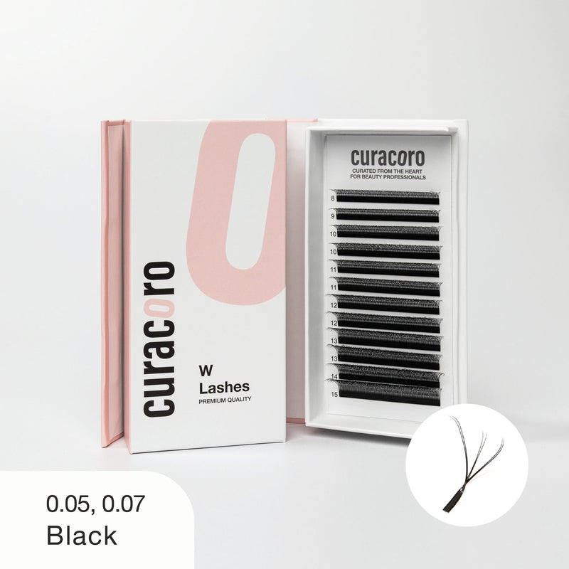 Curacoro W Lashes tray in black, featuring 0.05 and 0.07 thickness options, displayed in an open pink and white box on a white background.