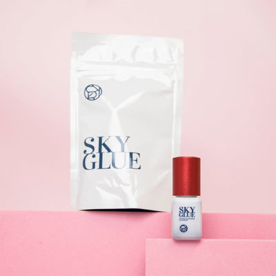 Sky Glue bottle for lash extensions with white packaging in the background