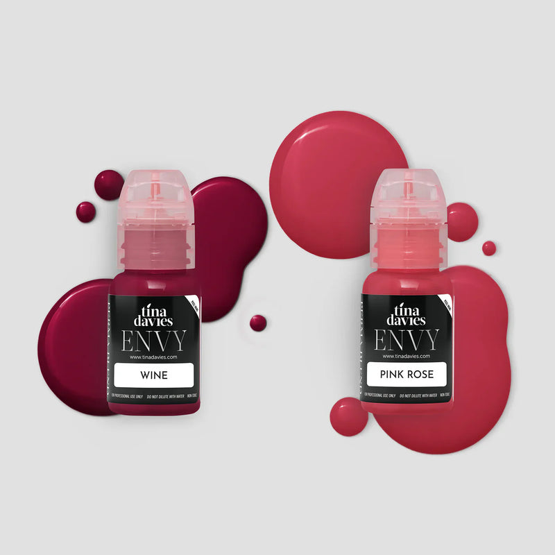 Tina Davies Envy Wine and Pink Rose lip pigment bottles with matching pigment spills on a light grey background.