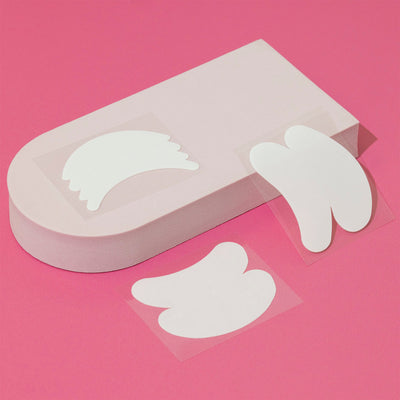 Bio Gel Eye Pads in various styles displayed on a mini podium against a pink background