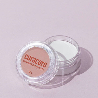 Image of our Contour Brow Paste standing in front of a pink background.