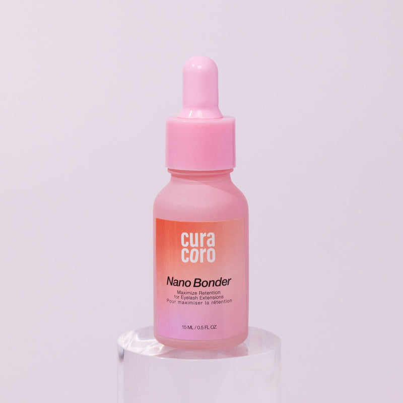 Curacoro Nano Bonder, 15 ml bottle, for maximizing eyelash extension retention, on a pink background.