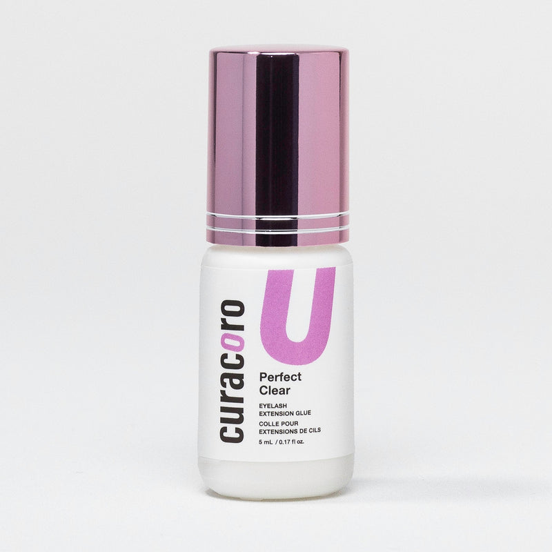 Curacoro Perfect Clear Eyelash Extension Glue in a 5mL bottle, featuring a white body and metallic purple cap, designed for precise lash application.