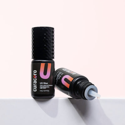 Curacoro UV glue for lash extensions, one bottle open with glue dripping.