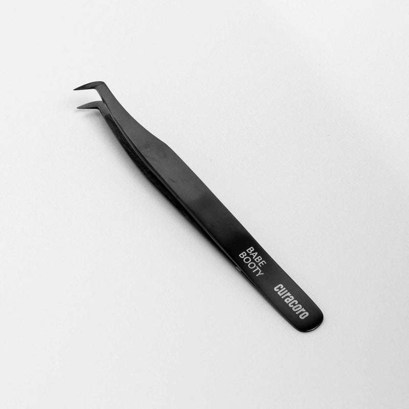 Babe Booty Tweezer Onyx over a white background. 