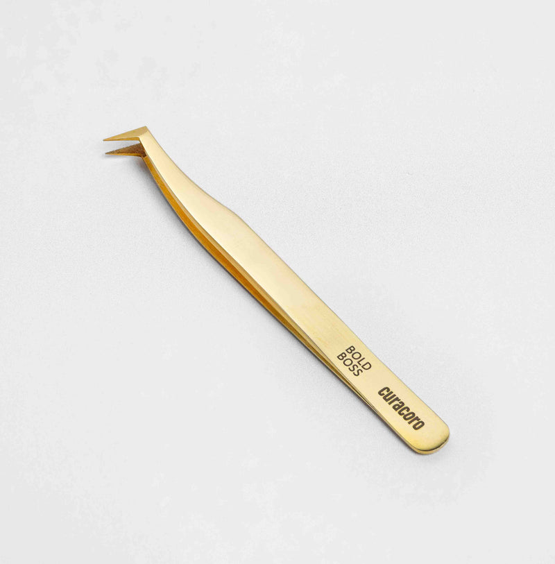 Curacoro Bold Boss Tweezer Gold style. over a white background. 