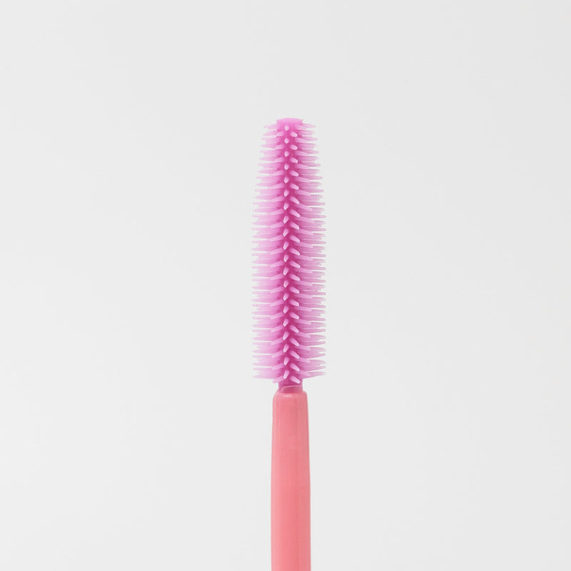 Image of the texture of a disposable pink silicon brush wands for eyelashes and brows.