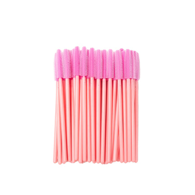 Image of disposable pink silicon brush wands for eyelashes and brows in a white background.