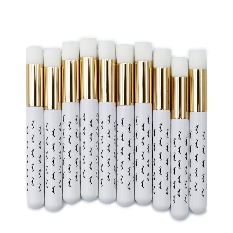 White wooden cleansing brushes over white background