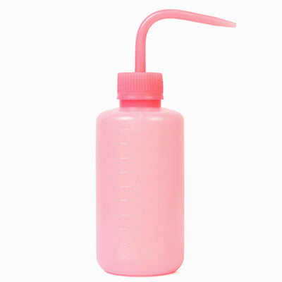 Pink Wash Bottle in front of a white background.